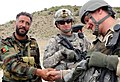 A Macedonian Soldier shakes hands with an Afghan National Army Soldier.