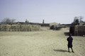 A boy in front of three mosques of Bani in the distance, 1983