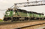 Three locomotives lead a Burlington Northern Railroad train westbound near Chicago in the 1990s
