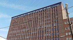 Image of a multistory brown brick square building