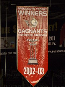 Banner hanging from ceiling of area spelling out words "President's Trophy Winners 2002-03"