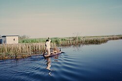 a fisherman riding a boat