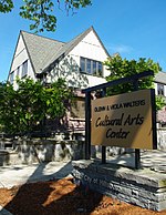 Sign in front of the Center with the building in the background