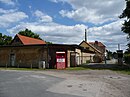 Alte Mosterei der Siedlung Eden, bestehend aus Obstverwertungsbetrieb mit Bürotrakt, Kesselhaus mit Schornstein, Obstlager- und Verkaufsgebäude, Presshaus, Tanklager I-III, Werkstatt, Garage und Lagerhalle