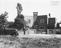 Burns Dick standing outside of The Wedge, built 1934