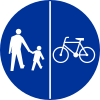 C-13/16 sign indicating compulsory track for pedestrians and bicycles – pedestrians on left, cyclists on right