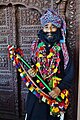 Sindhi sufi singer in ajrak turban, Kantha necklaces, and tamburo musical instrument of Sindh.