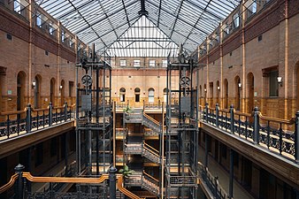 Interior of the Bradbury Building, with its exposed staircases and free-standing hydraulic elevators, Los Angeles, USA, by George Herbert Wyman, 1889-1893[222]