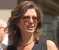 A head shot of singer Amy Grant, who is wearing sunglasses.