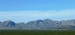 View of Ivanpah Solar Electric Generating System from Yates Well Road, San Bernardino County, California. The Clark Mountain Range can be seen in the distance.