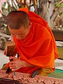 Image 2Lao monk woodworking temple details (from Culture of Laos)