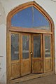 A wooden door that leads to the mausoleum of the martyrs who were killed in the Iranian Revolution