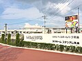 The Shinkansen Station with HAWKS Baseball Park Chikugo. An 800 Series train on a Tsubame service passing through the station is on the back.