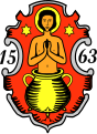 Gemeinde Veitshöchheim In Rot aus einem dreibeinigen goldenen Ölkessel wachsend der golden nimbierte, nackte heilige Vitus, beseitet oben von je einem sechsstrahligen goldenen Stern.