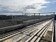 Railway tracks lowering down in concrete dive structure