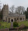 Stone building with square tower.