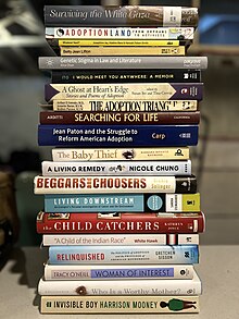 A stack of twenty books with spines displayed. The book titles are: Surviving the White Gaze, AdoptionLand: From Orphans to Activists, Whatever Next, Betty Jean Lifton, Genetic Stigma in Law and Literature, I Would Meet You Anywhere, A Ghost at Heart's Edge, The Adoption Triangle, Searching for Life, Jean Paton and the Struggle to Reform American Adoption, The Baby Thief, A Living Remedy, Beggars and Choosers, Living Downstream, The Child Catchers, "A Child of the Indian Race," Relinquished: The Politics of Adoption and Privilege of American Motherhood, Woman of Interest, Who is a Worthy Mother?, and Invisible Boy