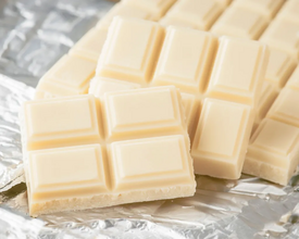 White chocolate bars broken along segments, on foil