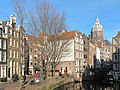 Amsterdam, vfiew to a street (Oudezijds Voorburgwal) with churchtower (de Sint Nicolaaskerk)