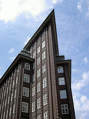 The distinctive sharp edge of a ten-story red brick building.