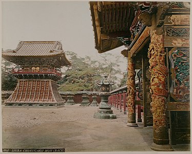 Adolfo Farsari: Shiba Chokugaku Mon (back). Yūshō-in Mausoleum complex showing the bell tower and Chokugaku gate, Zōjō-ji, Tokyo, between 1885 and 1890. Hand-coloured albumen print on a decorated album page.