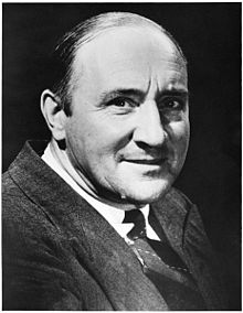 Head and shoulders of smiling man in a suit and tie