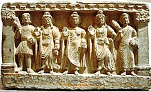 An early Mahayana Buddhist triad. From left to right, a Kushan devotee, the Bodhisattva Maitreya, the Buddha, the Bodhisattva Avalokitesvara, and a Buddhist monk. from the 2nd-3rd century AD