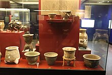 Museum display of assorted pots