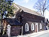 A stone building with Gothick-style windows containing lattice tracery