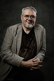 photo portrait of bearded man, seated