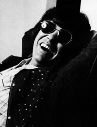 A black-and-white photograph of singer and musician Ronnie Milsap posing in front of the camera.