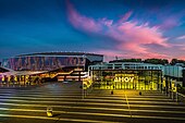 Picture of the Rotterdam Ahoy against a blue-pink sky.