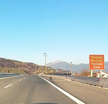 Road sign with the inscription "Foinikas River" (On the Olympia Odos highway bridge over the river)