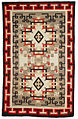 A wool rug ca.1900-1920 from the Navajo people in the Early Crystal style, with key patterns forming the outer border.