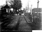 Haagweg gezien naar het noordoosten met op de voorgrond de Staatsspoorbrug met stoomtram van de Voorburgse lijn. Ca. 1904