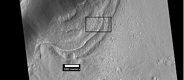 Context for the next image of the end of a flow feature or glacier. Location is Hellas quadrangle.