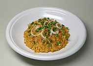 A plate of Obatzda, garnished with white and green onion