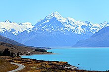 A large mountain with a lake in the foreground