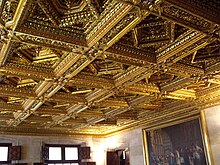 view of the ceiling made of carved wood in squares with smaller squares set inside each as a diamond