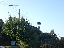 A white stork’s nest atop a pylon in the village