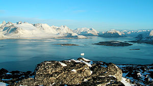 A typical scene from southern Greenland, near Nanortalik, where fjords and mountains dominate the landscape. Note the small iceberg in the foreground.