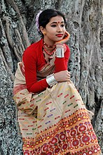 An Assamese girl wearing mekhela sador dress and bindi on the centre of her forehead.