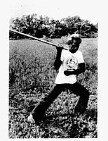 A martial artist wielding an arnis or eskrima