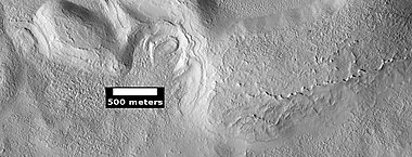 Dipping layers and layers of mantle, as seen by HiRISE under HiWish program. The dipping layers look similar to layers of mantle.