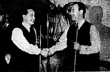 photo of two men shaking hands.