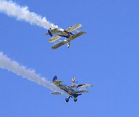 The UK Utterly Butterly display team perform wing walking with their Boeing Stearmans in 2006.