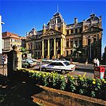 A three-storey structure on the Church Street facade extending down Gallwey Lane becoming a double s The building was commenced in 1895 to house the Natal Colonial Government departments and completed Architectural style: Renaissance Style. Type of site: Courthouse Current use: Natal Museum offices. Walk up pedestrianised section of Church Street from the City Hall. Colonial Building is third on Ri. Historical and architectural- Built in the Late English Renaissance-Georgian Revival style