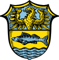 Gemeinde Utting a.Ammersee Schild geteilt; oben in Blau ein wachsender goldener Adler, unten in Gold ein blauer Fisch über blauen Wasserwellen.