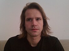 A photo of a blond long-haired Estonian man