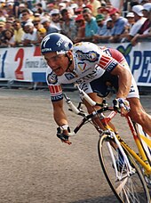 A man riding a bike in a cycling jersey.